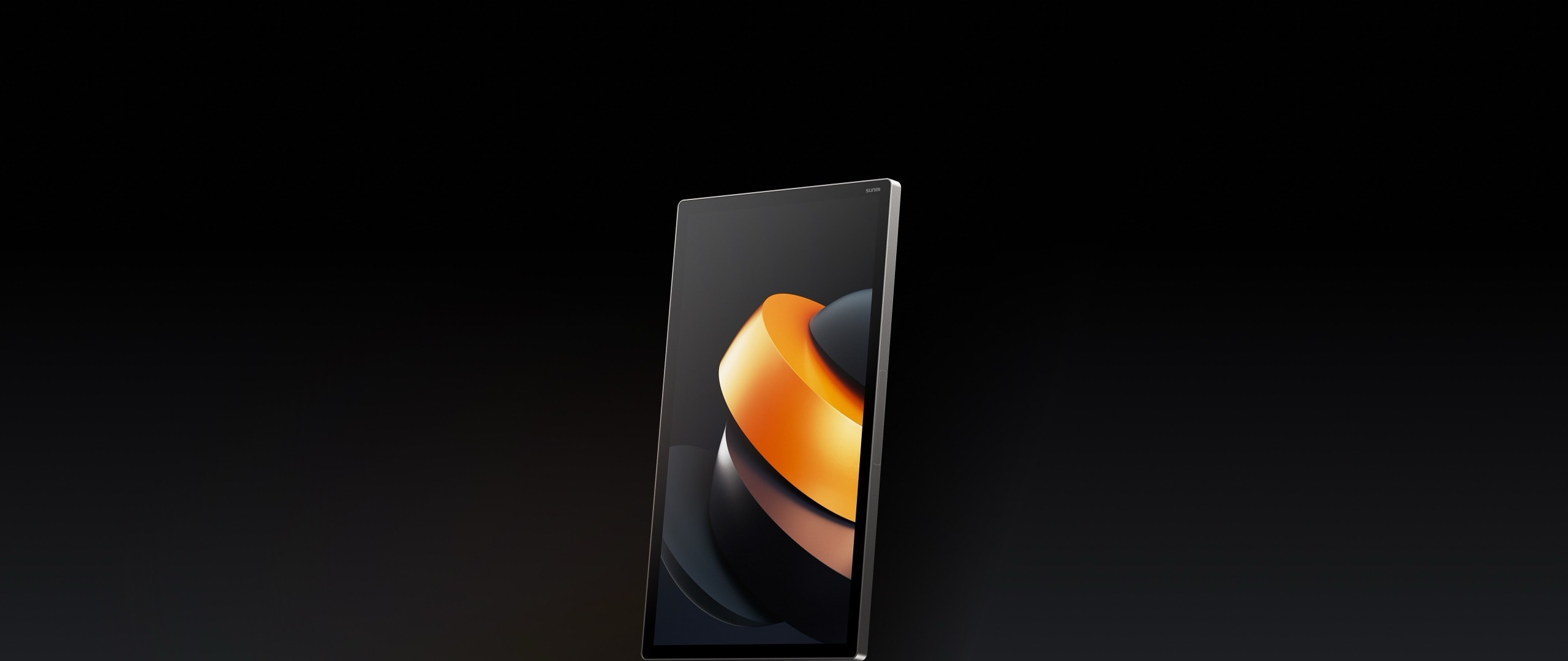The kiosk's screen seen at an angle on black, an abstract in orange and grey on it