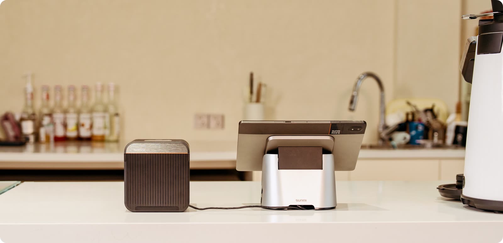 The printer on a café counter next to a point-of-sale terminal