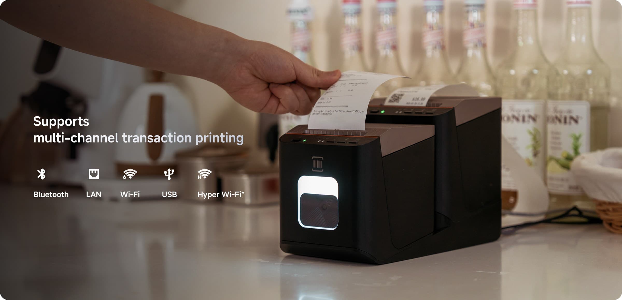 A receipt being lifted from a Final Print printer on a bar counter, captioned with the connections it supports: Bluetooth, LAN, Wi-Fi, USB and Hyper Wi-Fi